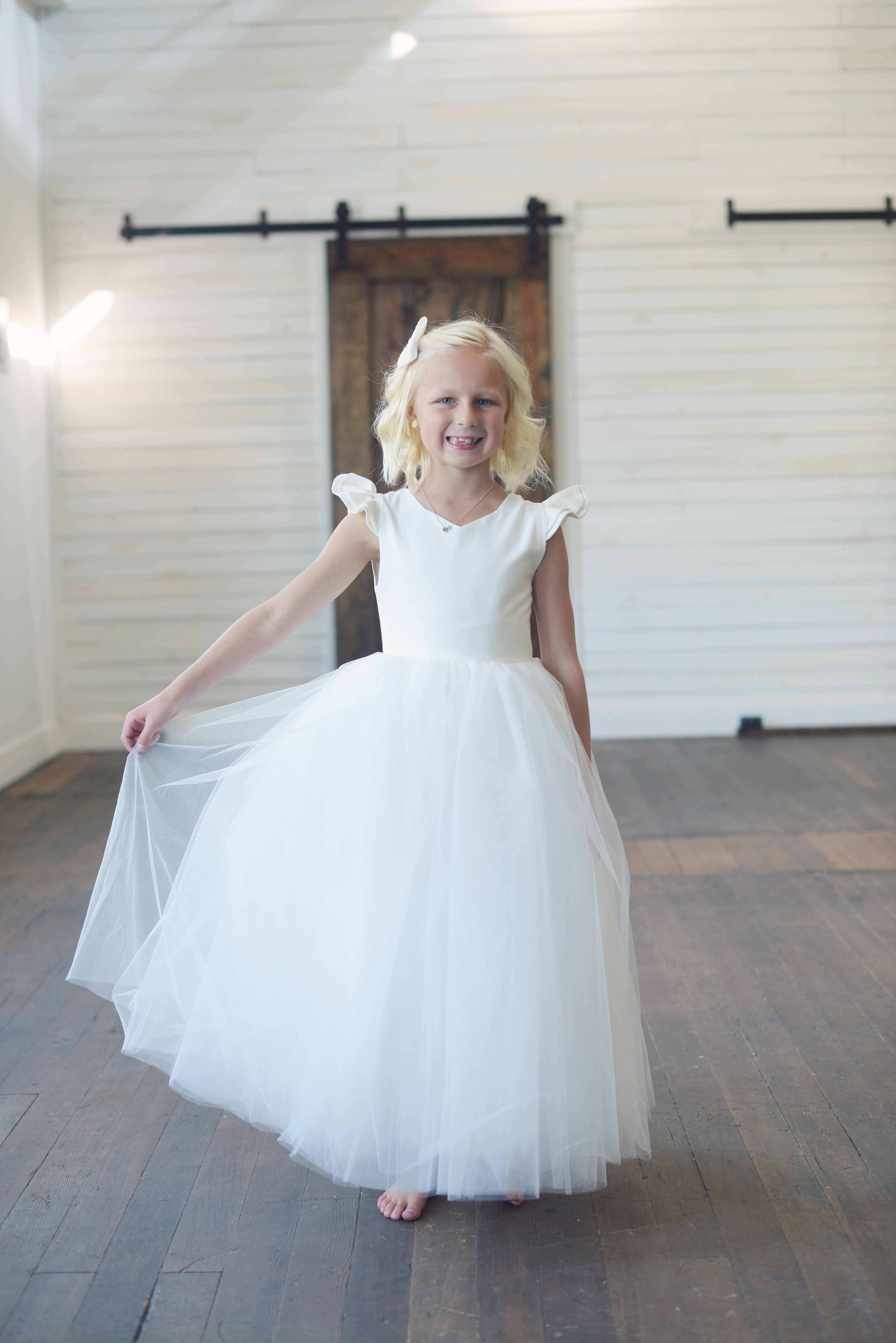 A photo of the Eynhallow flower girl or first communion dress in ivory or white tulle