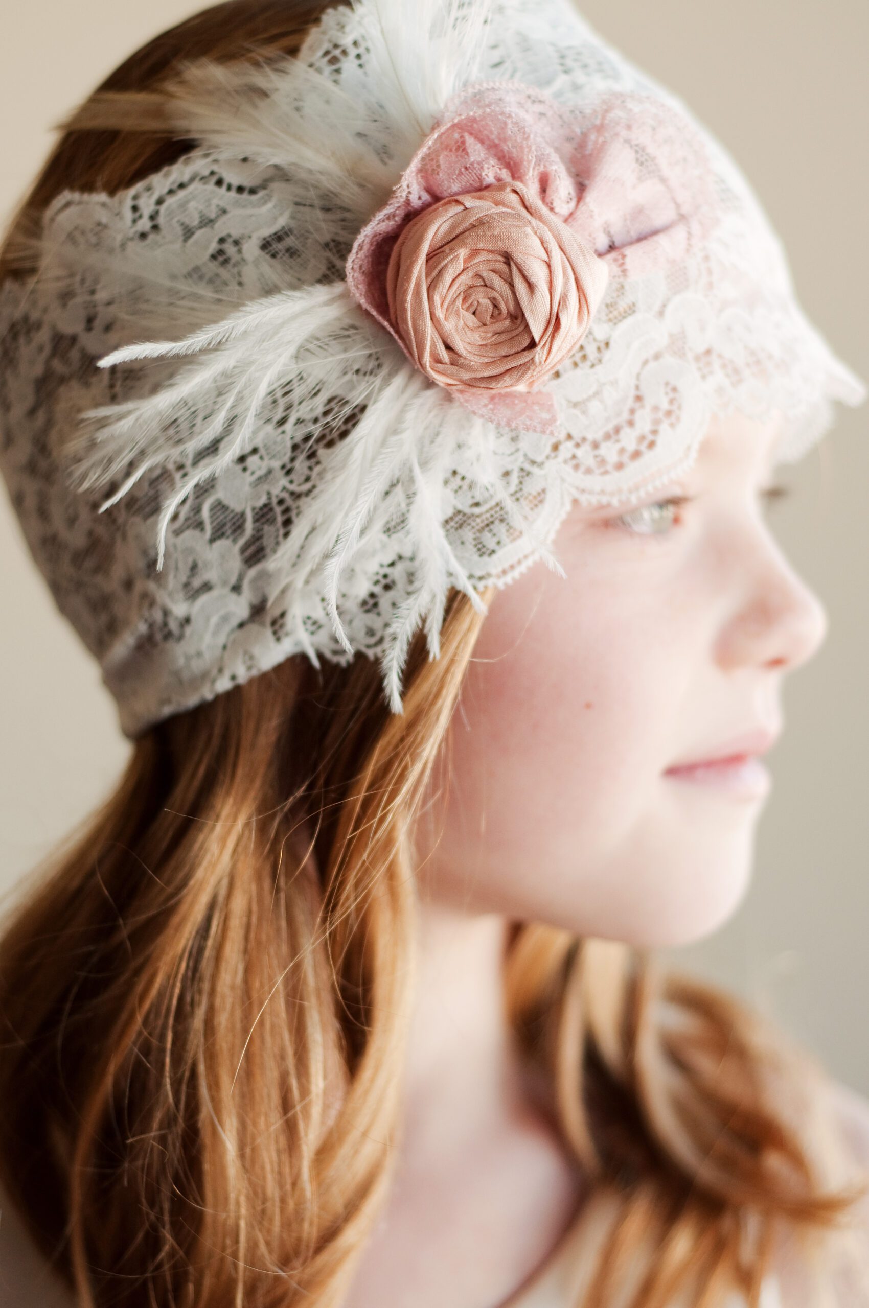 A photo of a lace flower girl headband with roses
