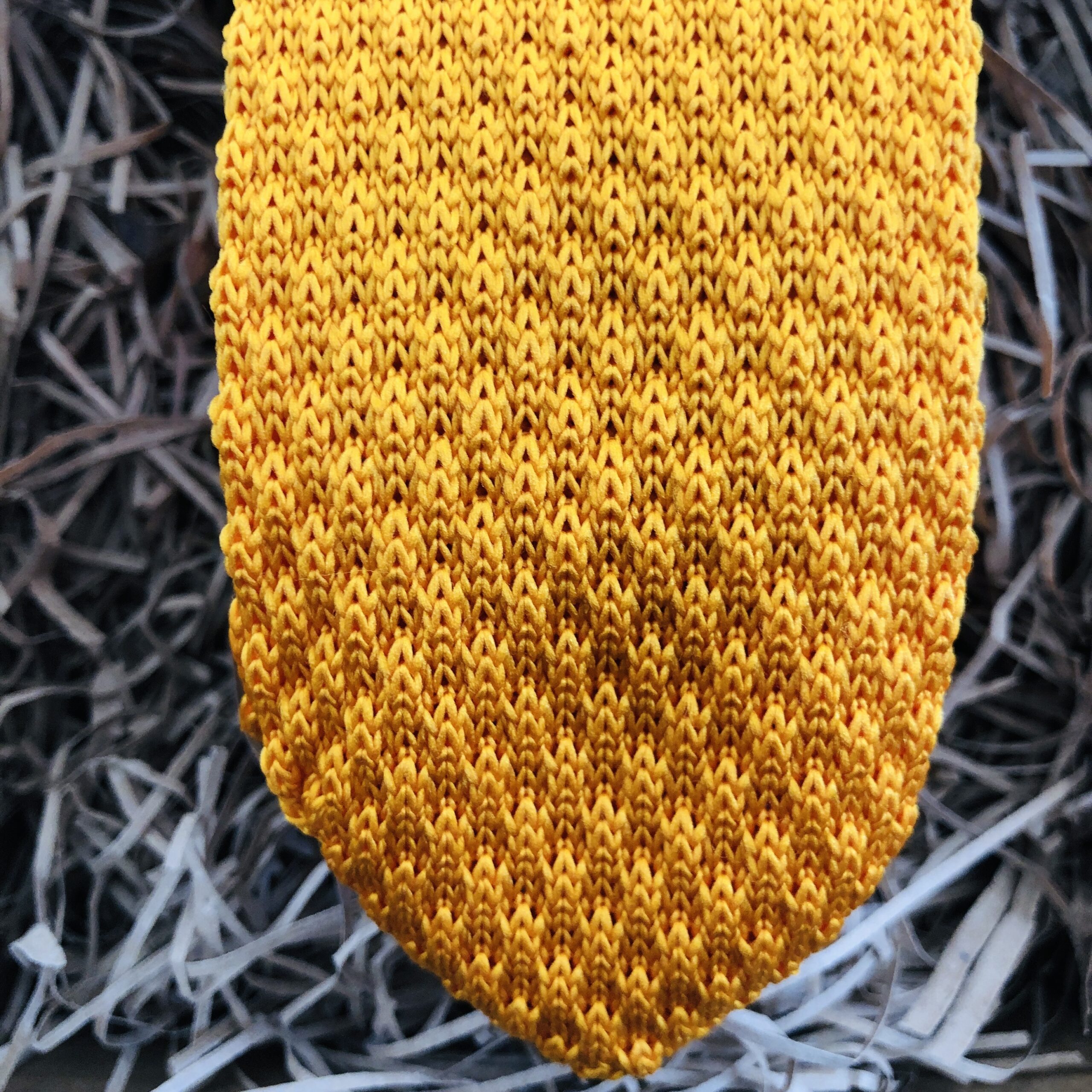 A photo of a gold knitted mens tie