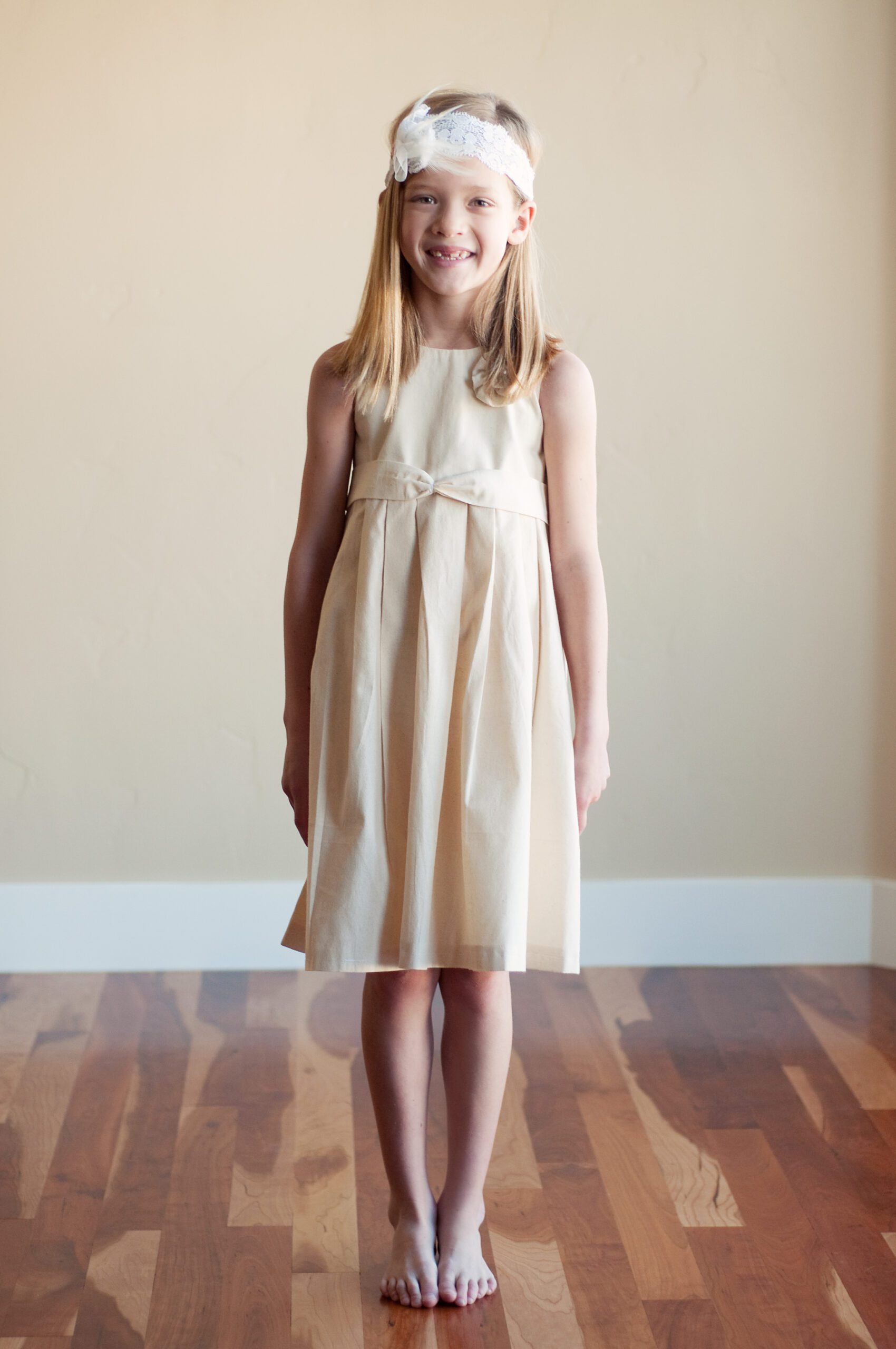 A Photo of a summer cotton flower girl dress in ivory or white