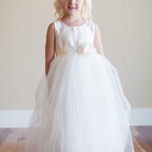 A photo of a flower girl wearing an ivory silk and tulle dress