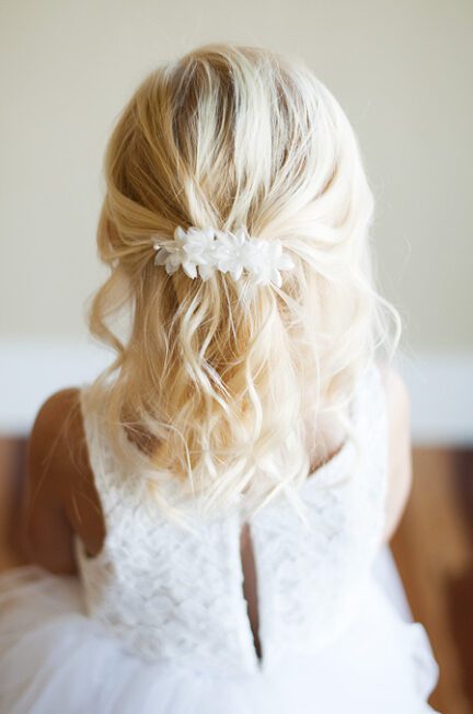 A photo of an ivory organza flower girl hairclip