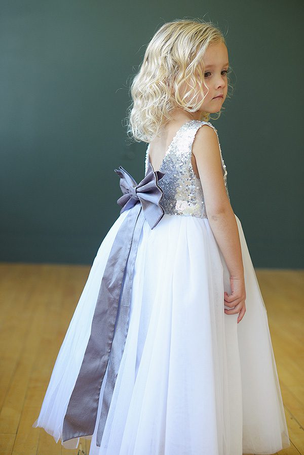 A Photo of a flower girl wearing a sequin and tulle dress