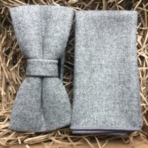 A photo of a grey wool bow tie and pocket square