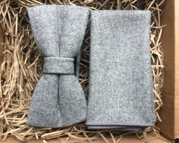 A photo of a grey wool bow tie and pocket square