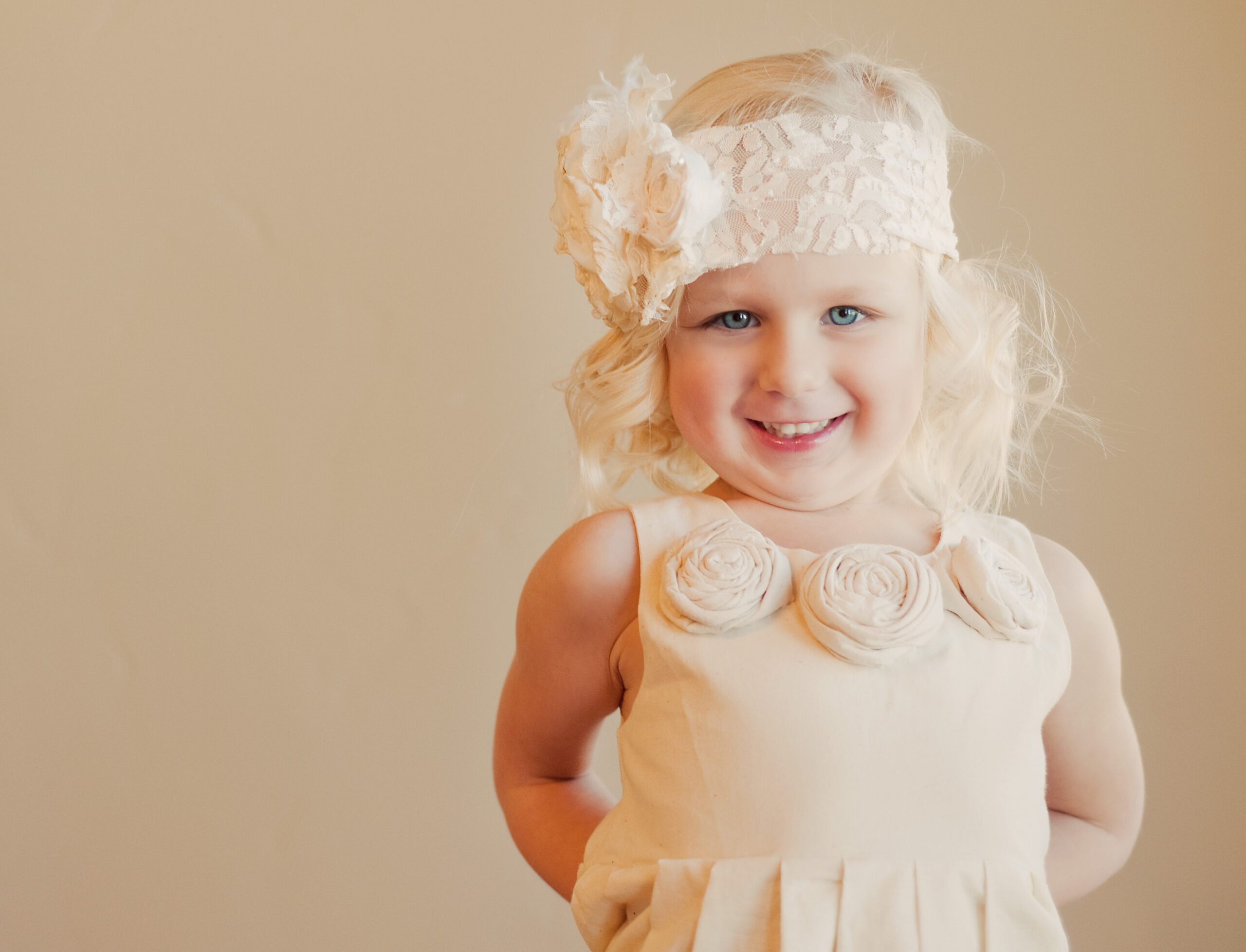 a 1920s style flower girl dress with rosettes on the collar. The dress is hand made to measure