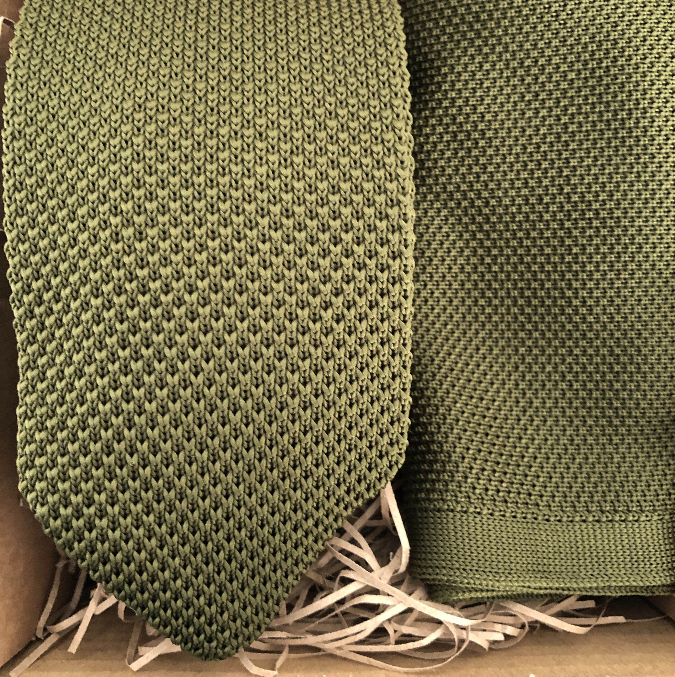 A photo of an olive green knit tie and pocket square for groomsmen