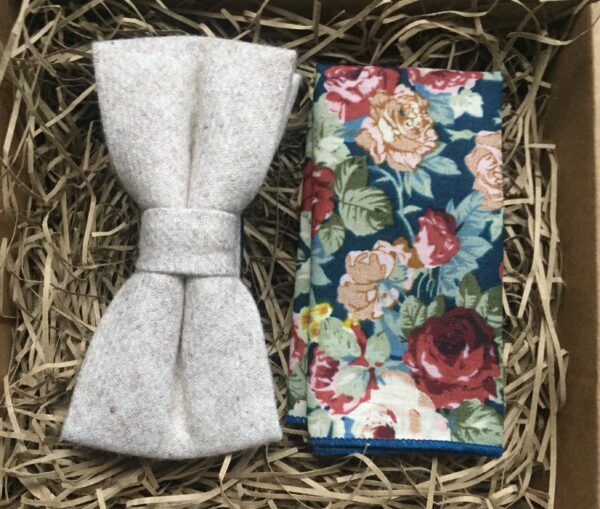 A photo of a cream wool bow tie and floral pocket square