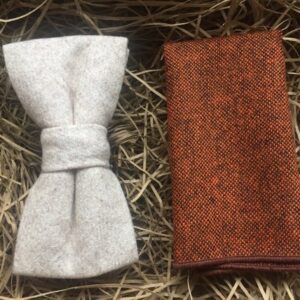 A photo of a cream wool bow tie and maple pocket square