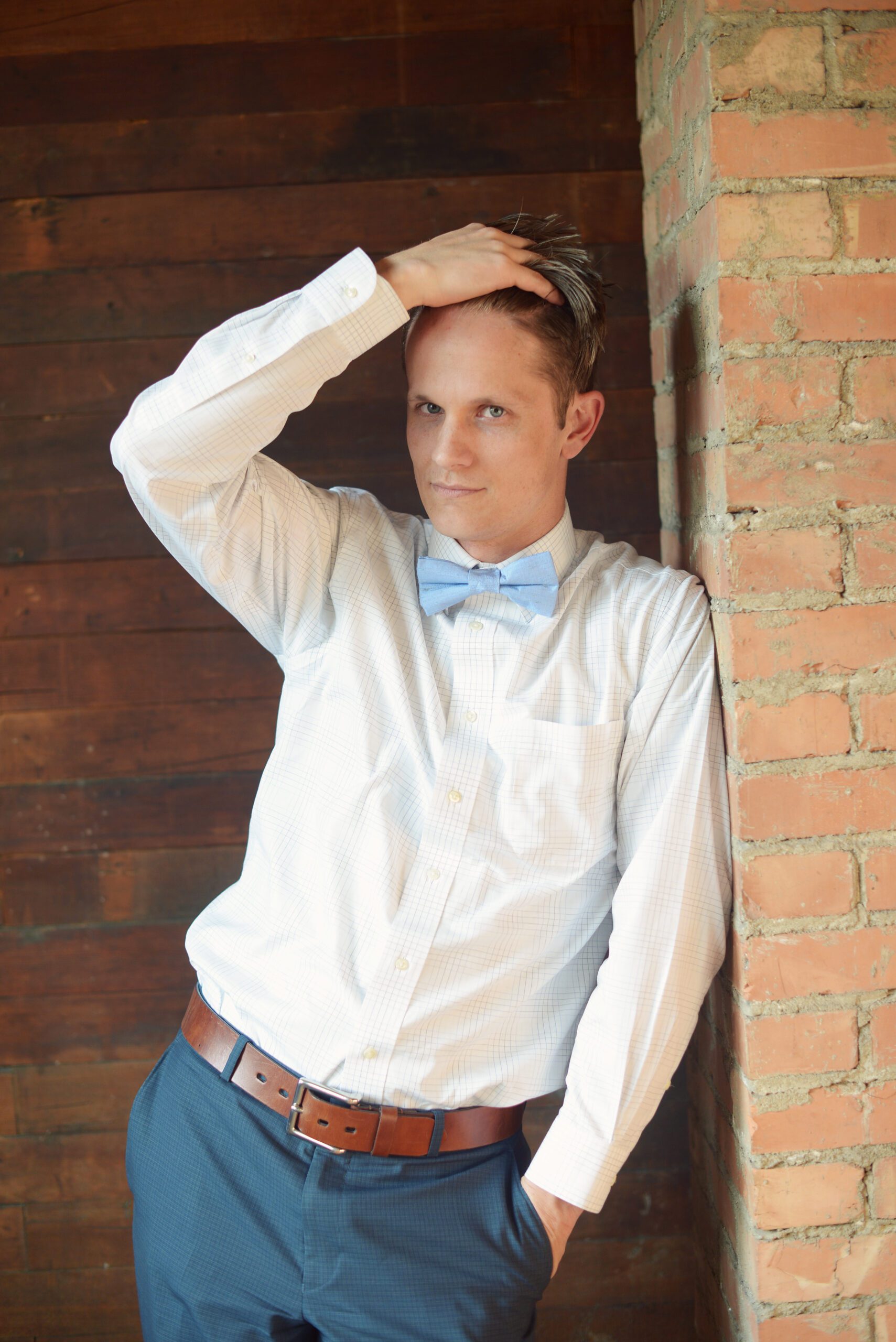 A photo of a man wearing a light blue silk bow tie which is hand made