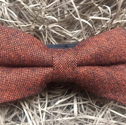 A photo of a burnt orange bow tie in flecked wool