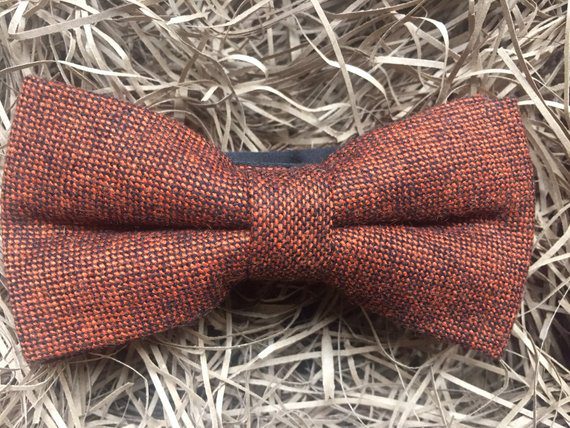 A photo of a burnt orange bow tie in flecked wool