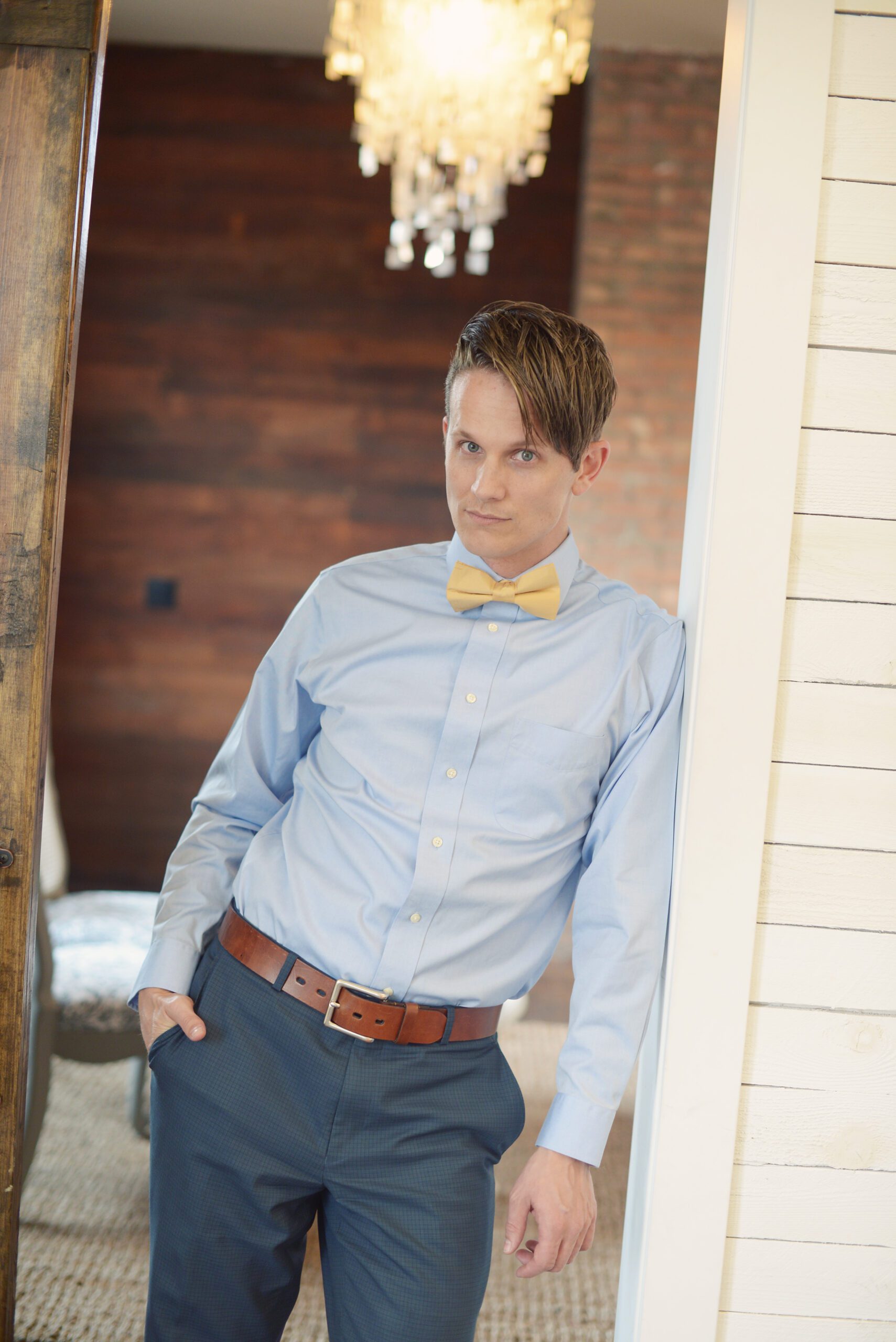 A photo of a man wearing a pure silk mustard coloured bow tie