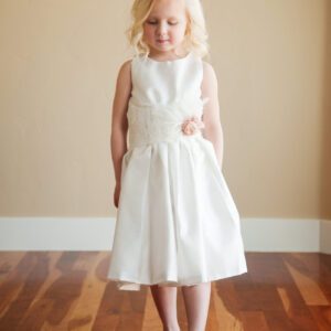 A photo of a 4 year old girl wearing an ivory cotton hand made flower girl dress