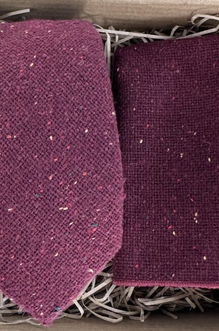 A photo of a burgundy flecked wool tie, bow tie and pocket square set