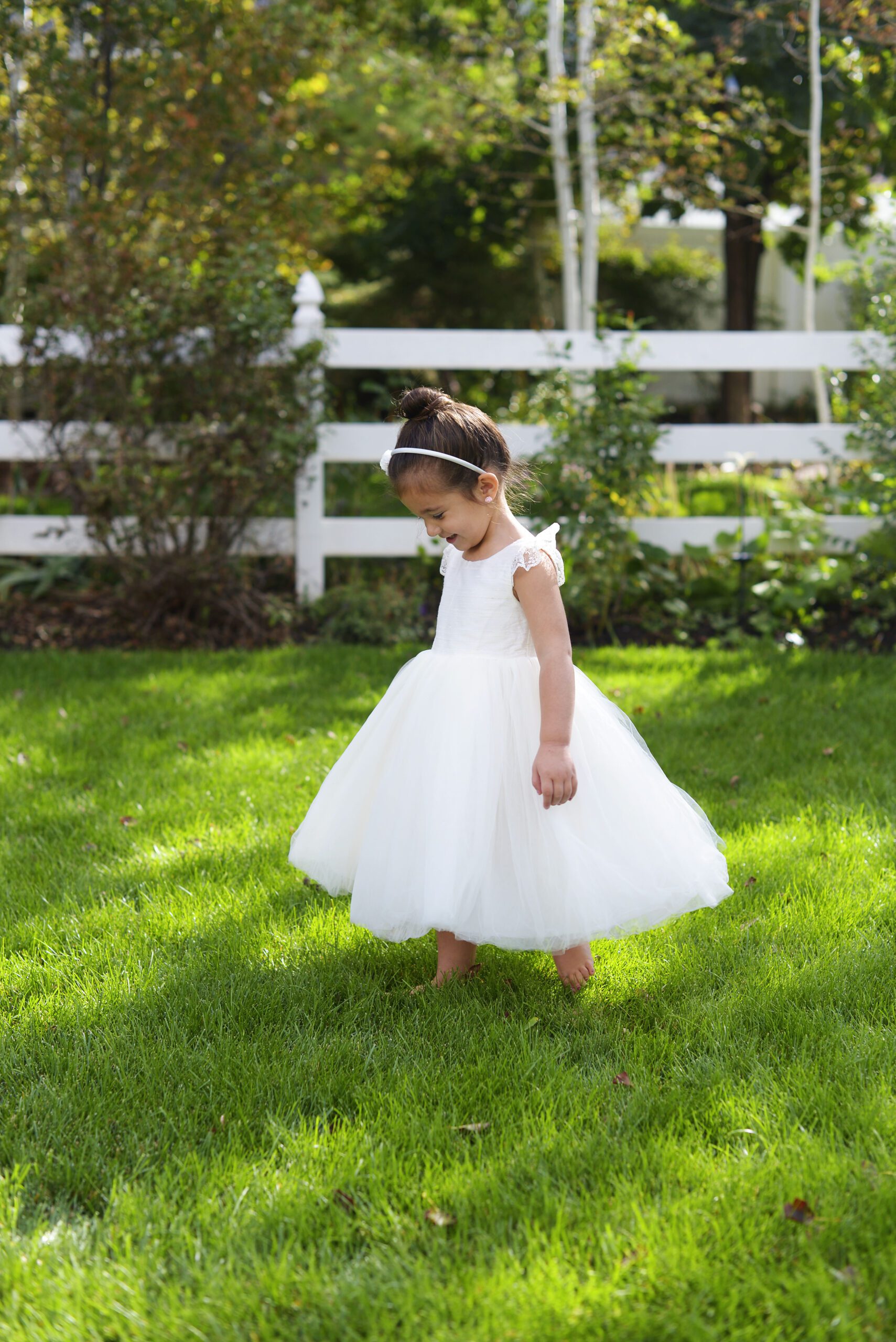 A photo of a girl wearing a ivory princess dress with a pure silk bodice and tulle skirt
