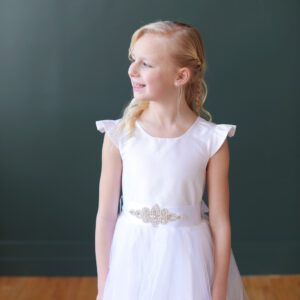 White silk communion dress with a tulle skirt and diamante belt.