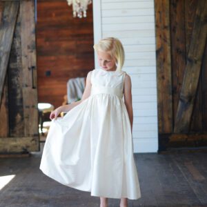 An ivory silk flower girl dress with Peter Pan collar also available in white.