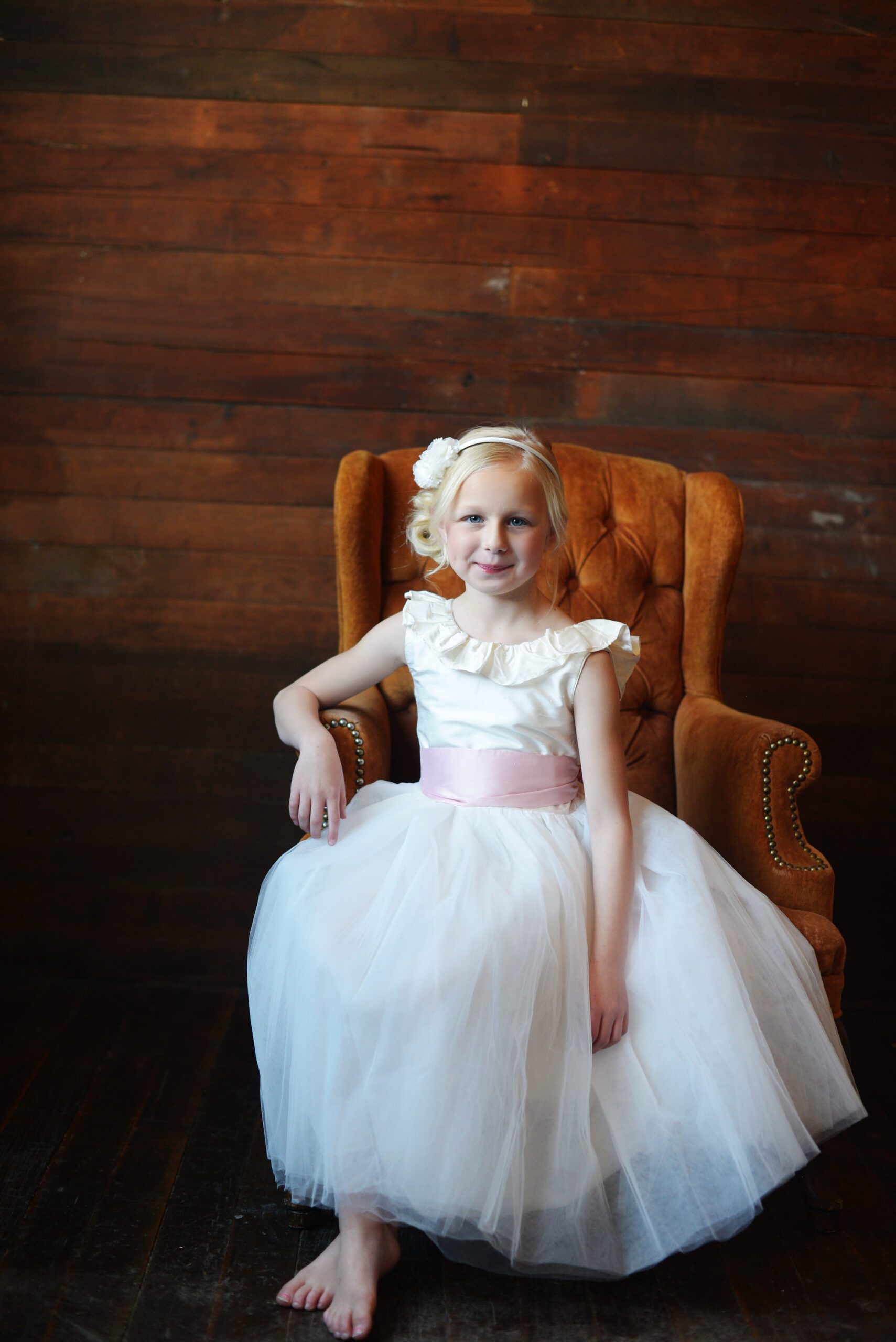 A photo of a ruffle silk ballerina dress in ivory silk and with a tulle skirt