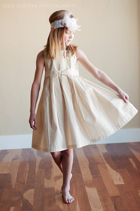 A photo of a girl wearing a summer cotton flower girl dress in ivory or white