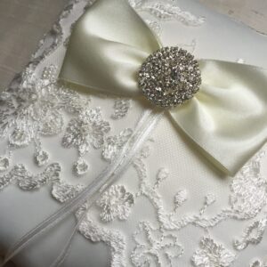 A photo of a delicate lace ring pillow with rhinestone detail will look stunning with any of our dresses.  The pillow in the photograph is a light ivory colour and we also make them in white.
