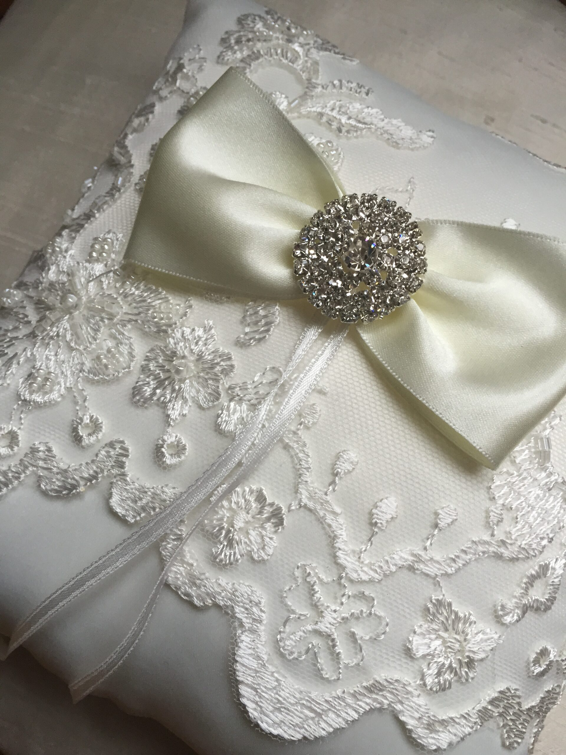 A photo of a delicate lace ring pillow with rhinestone detail will look stunning with any of our dresses.  The pillow in the photograph is a light ivory colour and we also make them in white.