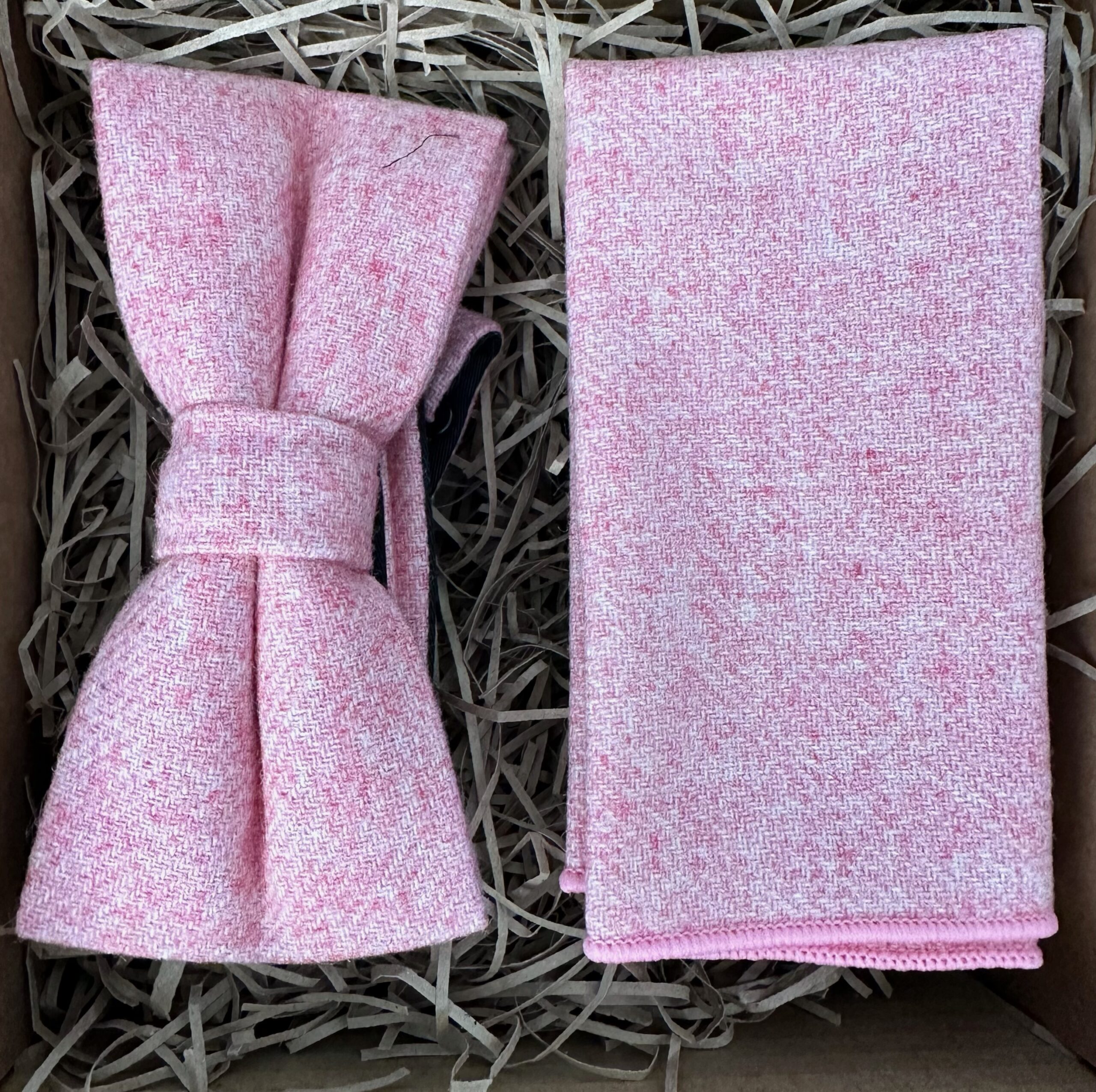 A photo of a pink wool bow tie and pocket square