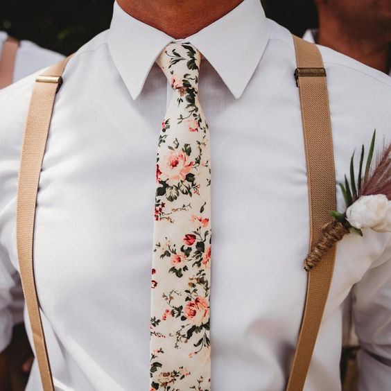 A photo of a groom wearing a pink floral tie