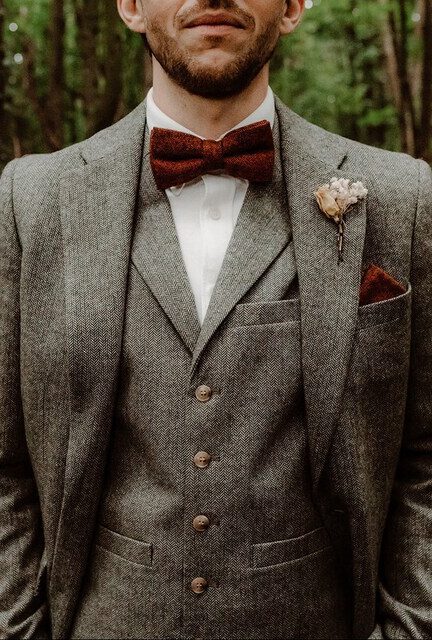 A photo of a groom wearing a wool burnt orange bow tie