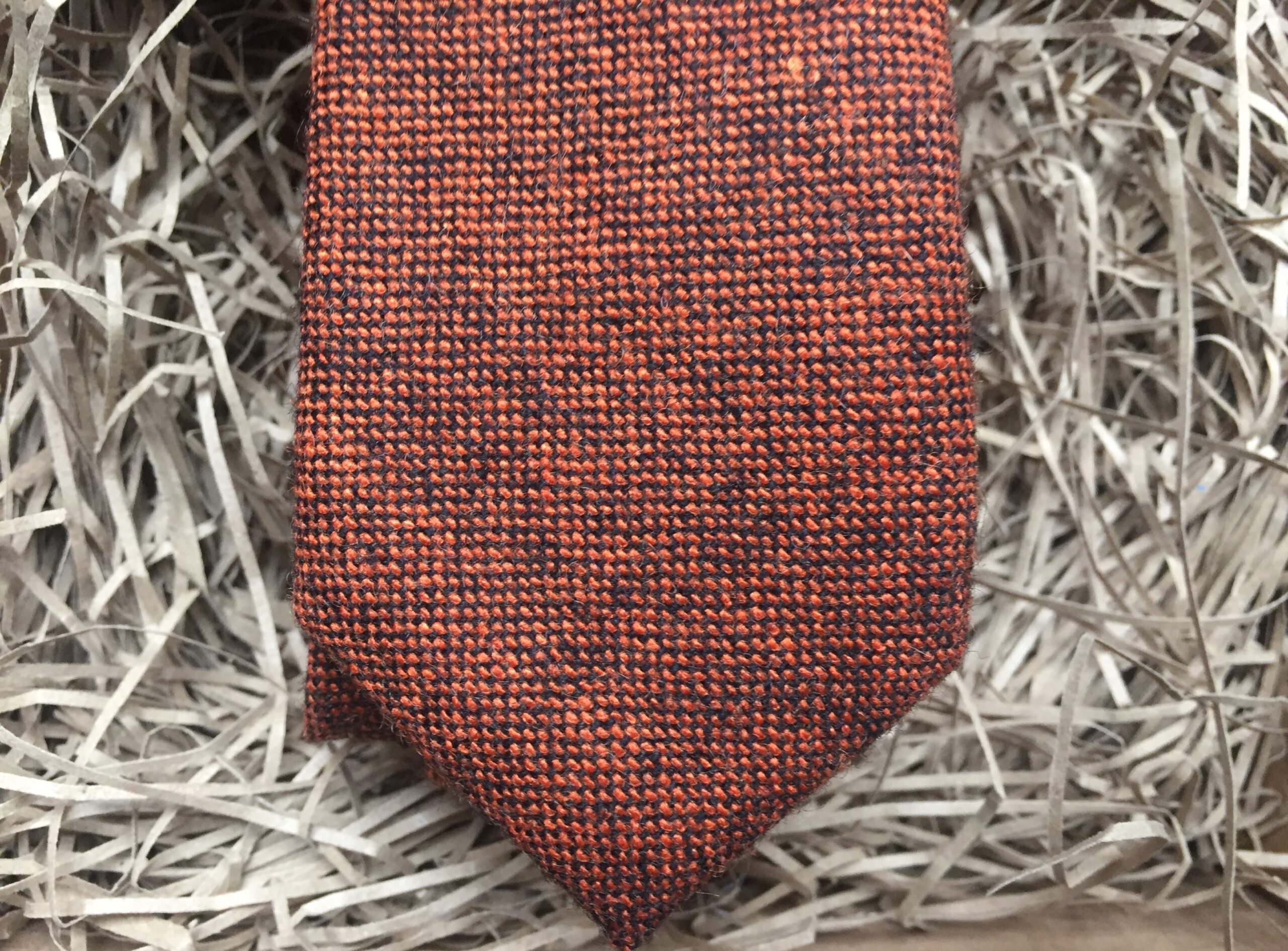 A photo of a burnt orange wool men's tie. IT is also available as a tie and pocket square set and in a bow tie.