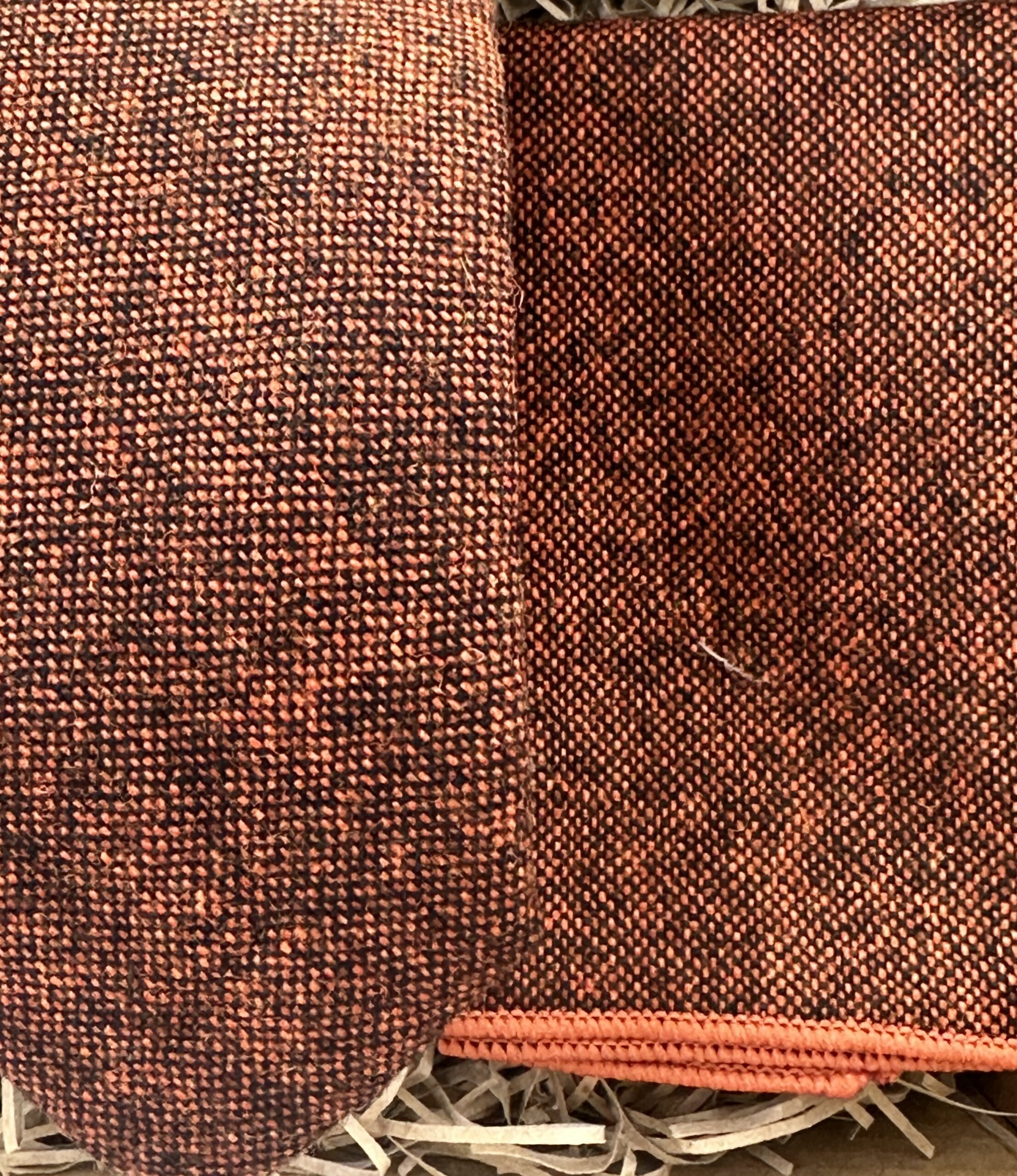 A photo of a burnt orange wool men's tie and pocket square