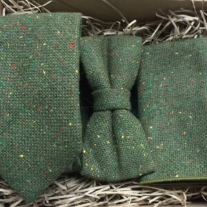 A photo of a moss green wool tie, bow tie and pocket square with coloured flecks in the wool