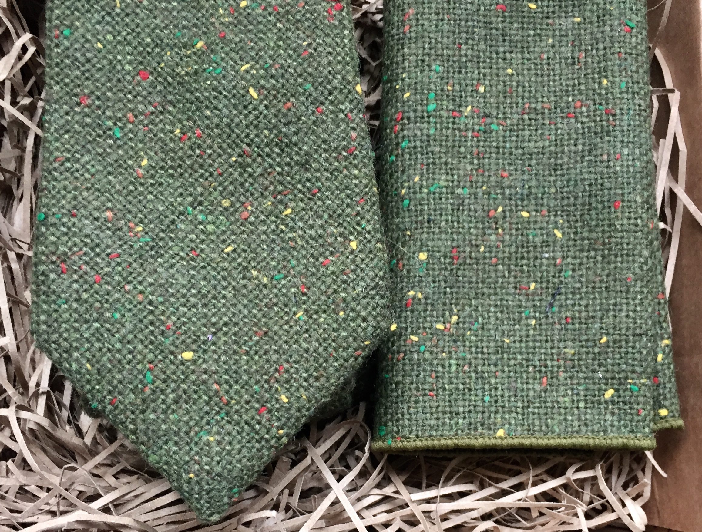 A photo of a moss green men's wool tie and pocket square set
