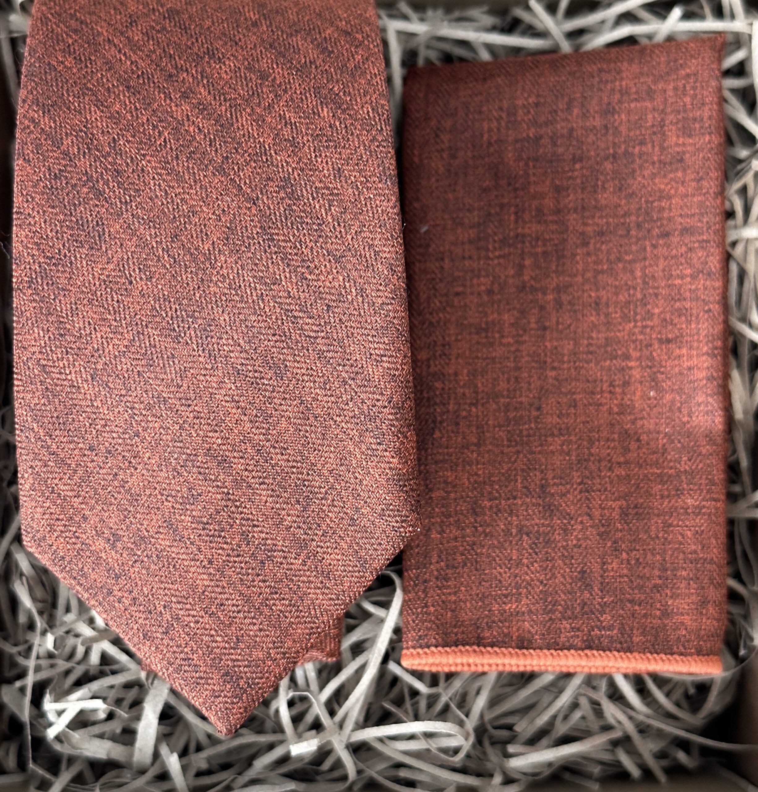 A photo of a man's burnt orange cotton tie