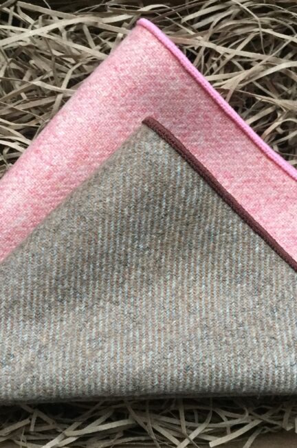 A photo of a pink and beige pocket square set in wool which is a perfect men's gift