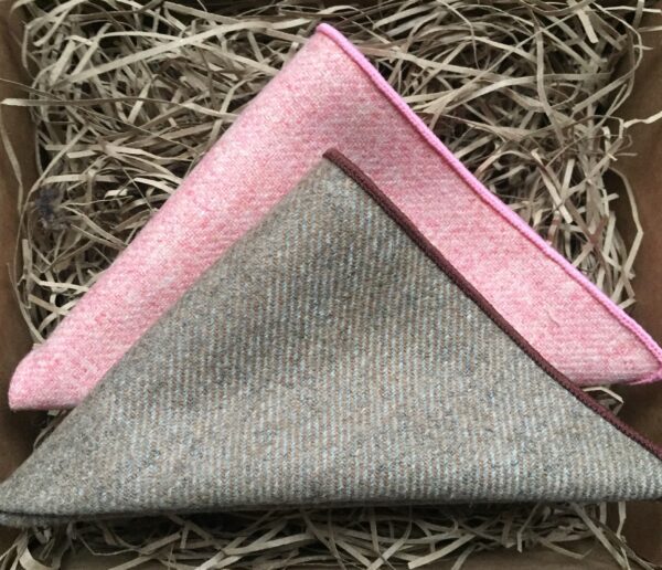 A photo of a pink and beige pocket square set in wool which is a perfect men's gift