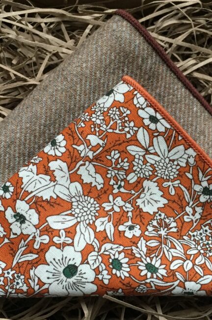 A photo of a set of pocket squares in beige wool and an orange floral pattern