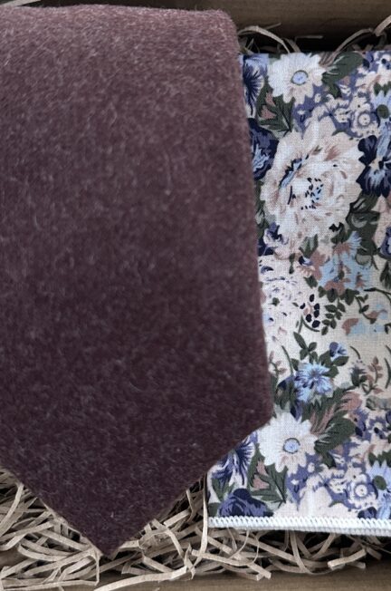 A photo of a brown wool tie and blue floral pocket square in cotton ideal as a mans gift and is in gift wrapping