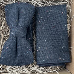 A photo of a flecked wool pre-tied bow tie and pocket square in wool