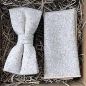 A photo of a cream wool bow tie and pocket square