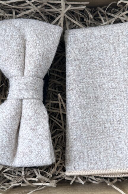 A photo of a cream wool bow tie and pocket square