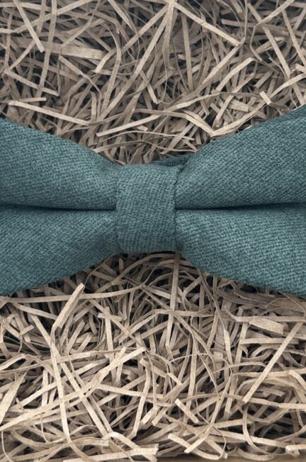 A photo of a dark green brushed cotton bow tie. The bow tie is pre-tied.
