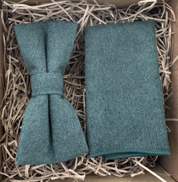 A photo of a dark green cotton bow tie and pocket square