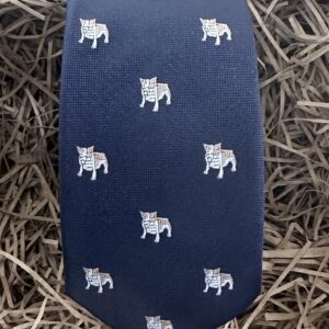 A photo of a mens tie with a bull dog pattern with a navy background