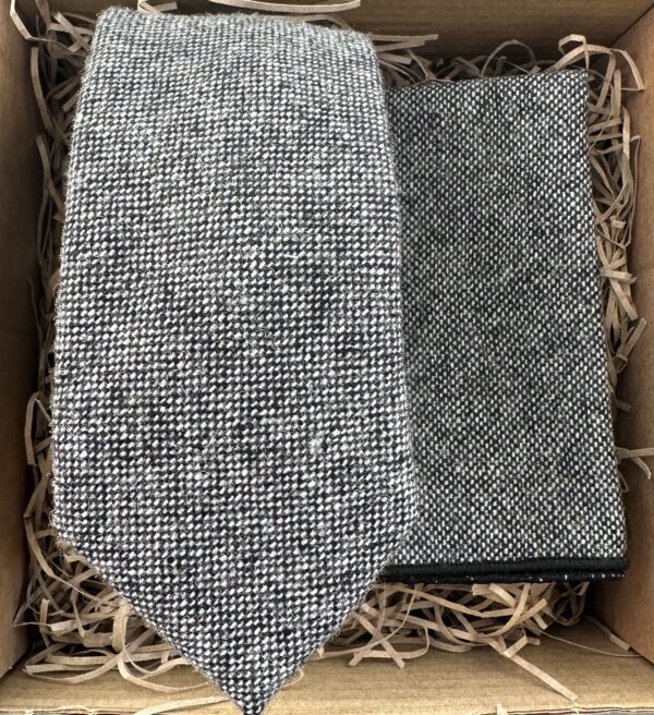 A photo of a grey flecked wool tie and pocket square set