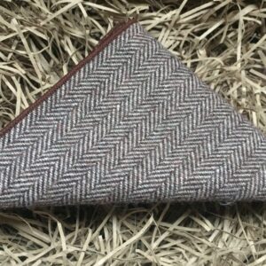 A photo of a brown, herringbone wool pocket square