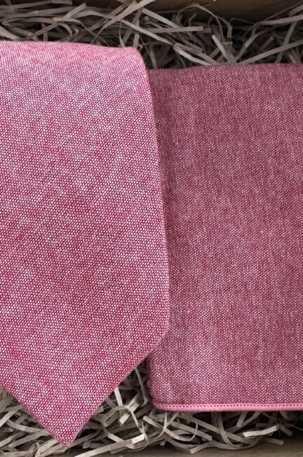 A photo of a dusky pink tie and pocket square set in cotton