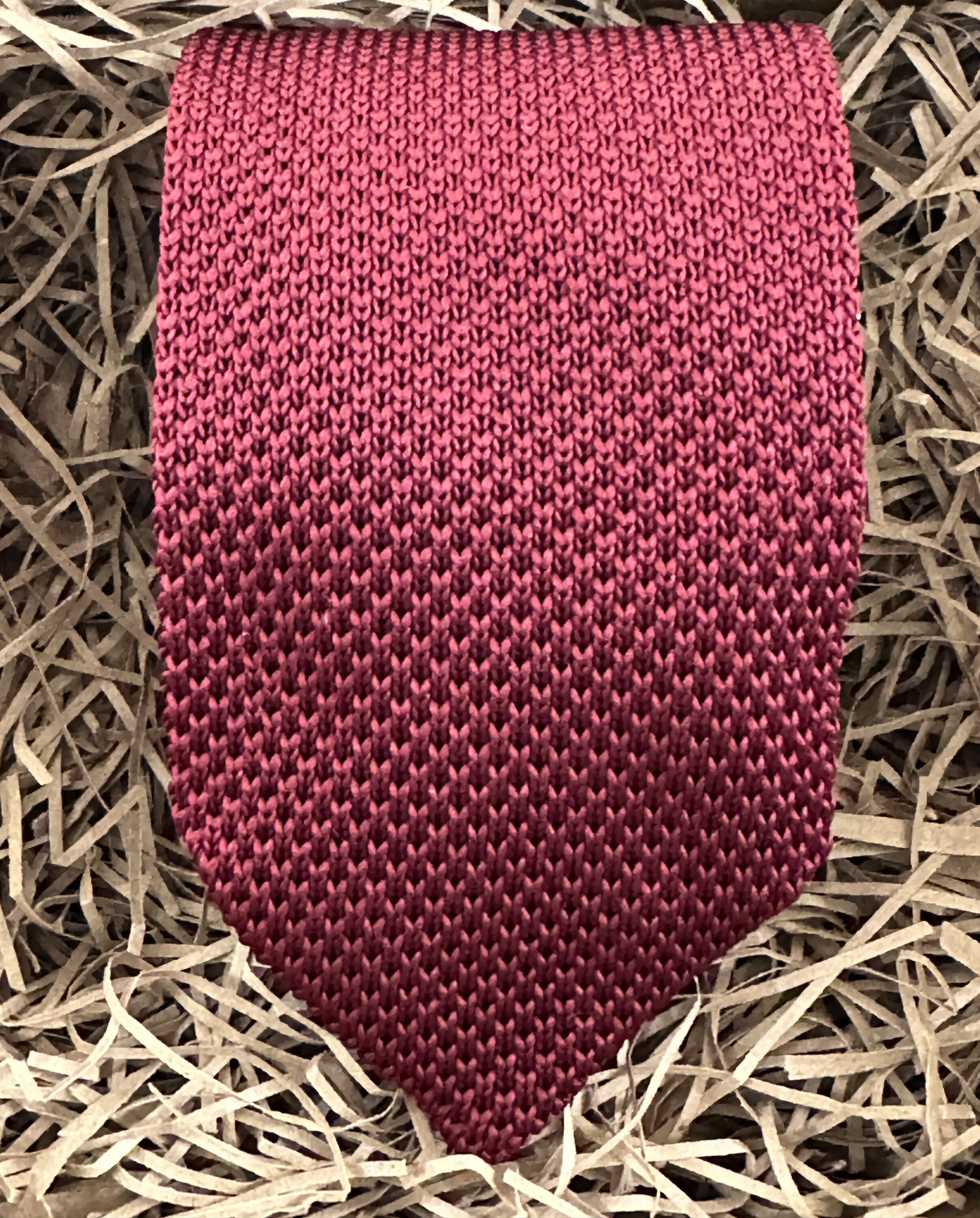 A photo of a red knitted tie