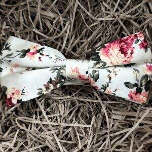 A photo of a pink floral bow tie. The bow tie is pre-tied and suitable for grooms and groomsmen gifts