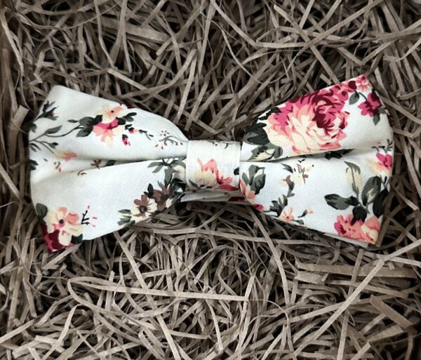 A photo of a pink floral bow tie. The bow tie is pre-tied and suitable for grooms and groomsmen gifts